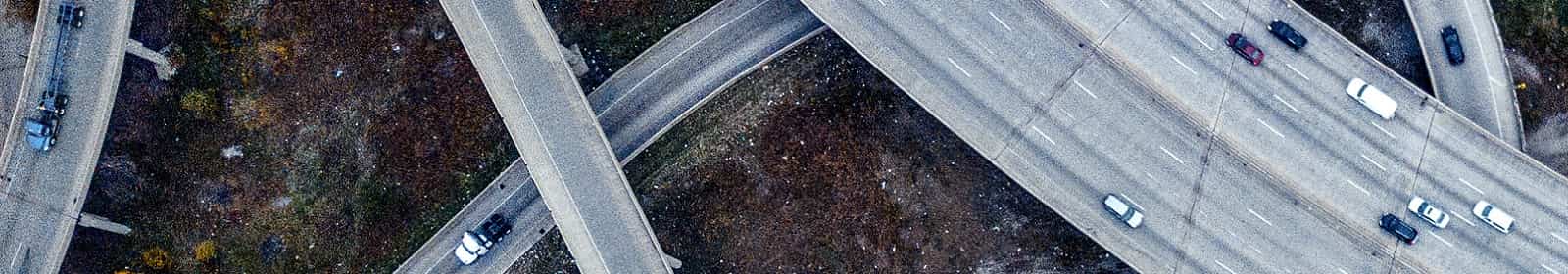 Cars drive on a freeway interchange