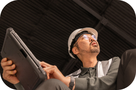 Person in a hard hat holding a tablet