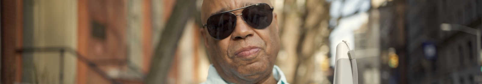 Man holding a WeWALK smart cane