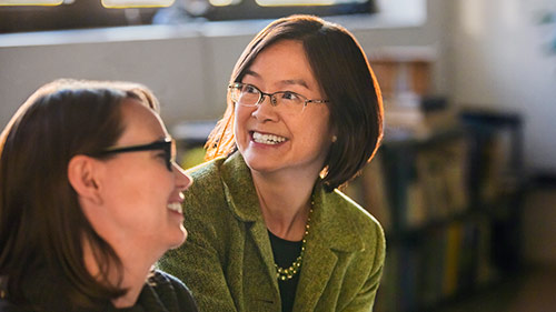 two women laughing in office