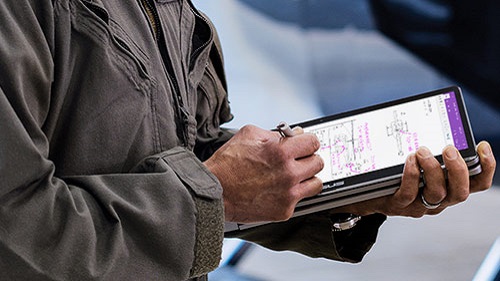 man writing on tablet