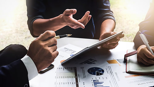 persons discussing on tablet