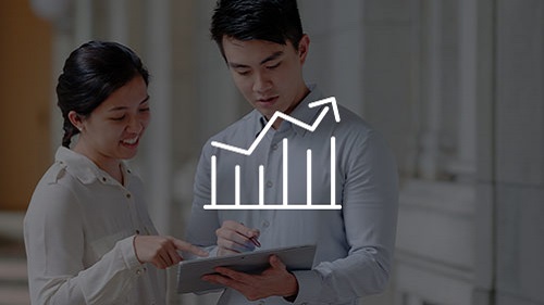 man and woman analyzing data on tablet