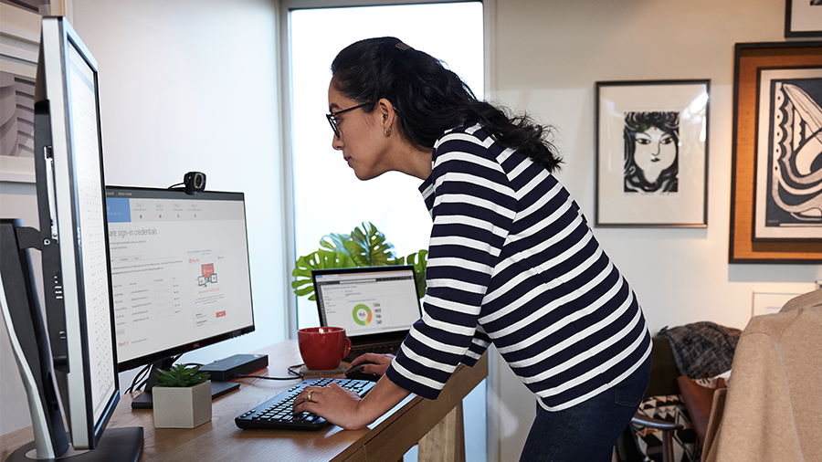 Person standing working at their desk