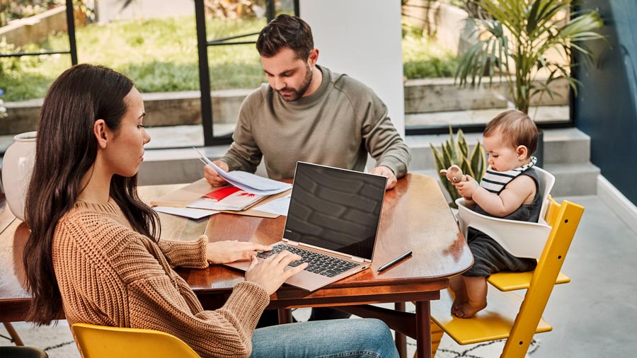 Family working at table with a laptop
