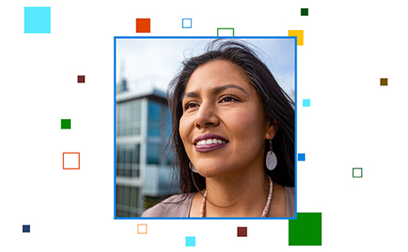 A portrait of a woman smiling, surrounding her are colorful #BuildFor2030 pixels