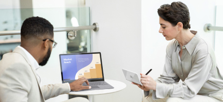 A professional makes a presentation on a laptop