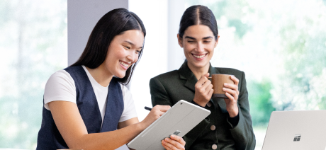 Two people looking at a tablet device.