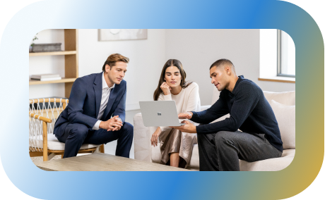 Three people looking at a laptop.