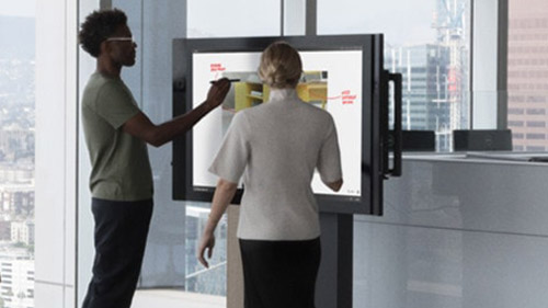 Man and woman working on Surface Hub