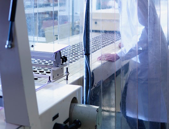 Picture of a person working at an assembly line