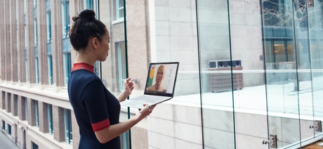 Woman holding a laptop talking on a video call