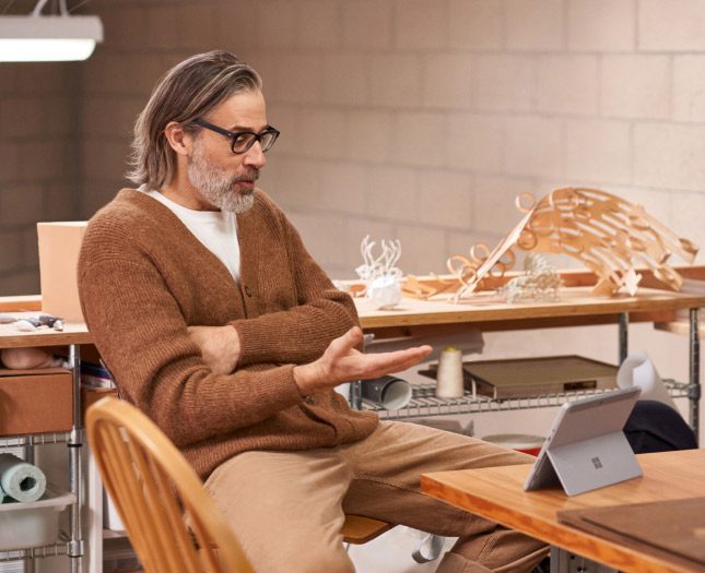 A man having a virtual meeting on his tablet