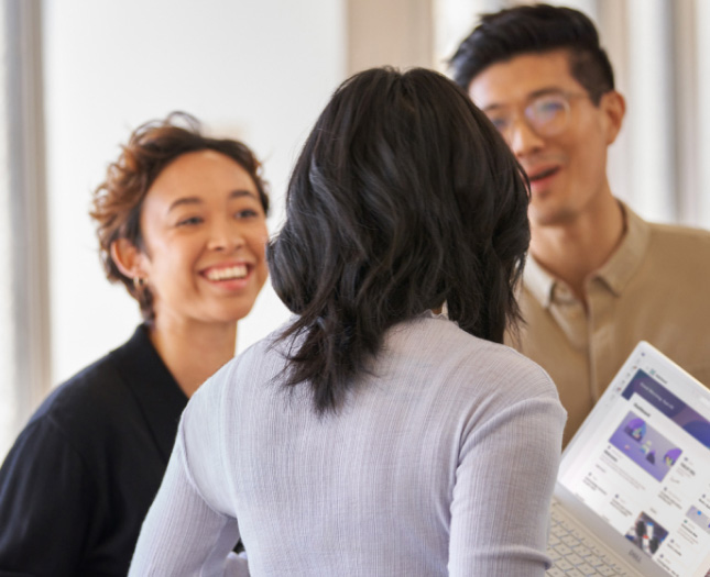 Three professionals having a happy discussion at the office