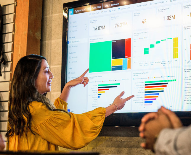 A professional gives a Power BI presentation at work