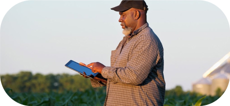 A person working on a tablet in a field