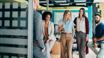 A group of coworkers chatting in an office space