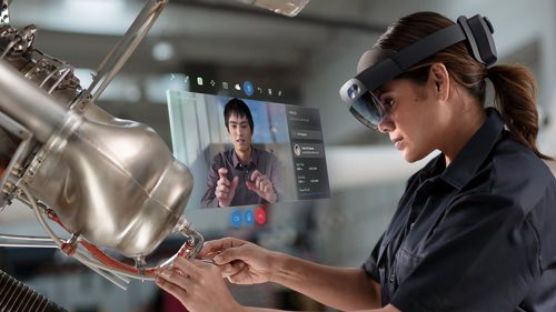Technician wearing an AR headset and working on a machine