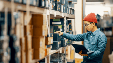 Warehouse worker using a device to locate an item