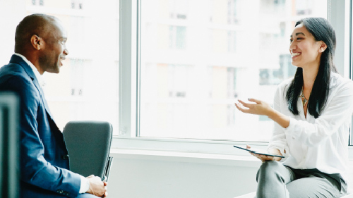 Smiling woman leading meeting at office 