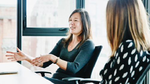Woman leading meeting in office conference room