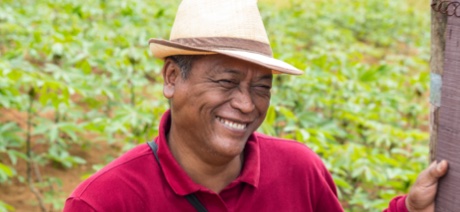 Person smiling outside wearing a hat
