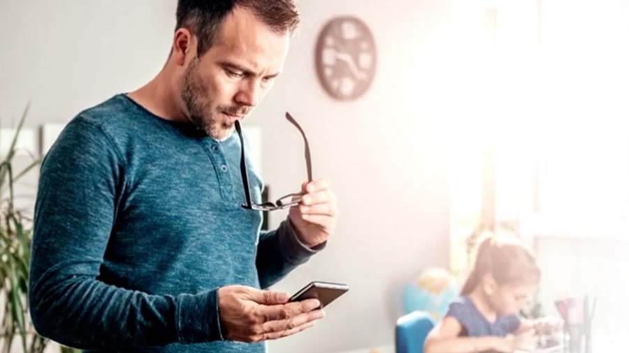 Man at home working on smartphone