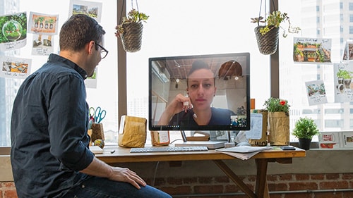 Man and woman having a video meeting
