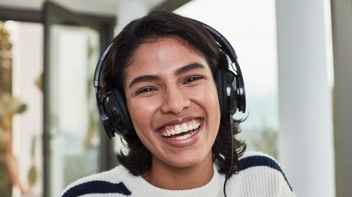 Person wearing headphones smiling