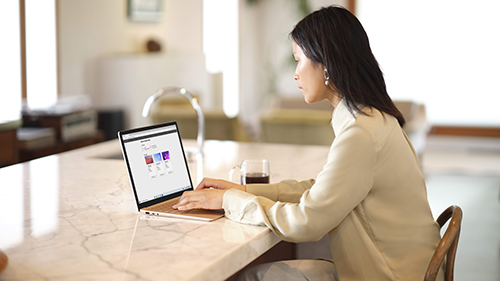 Woman sitting at table with laptop