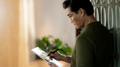 A person looking at the Surface device