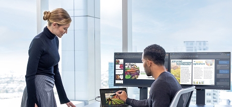 Two persons working with Surface device